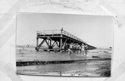 Old jetty in Swakopmund on sand
