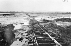 Railway line and bridge over Swakop River damaged by floods. Rails in water. Swakopmund 